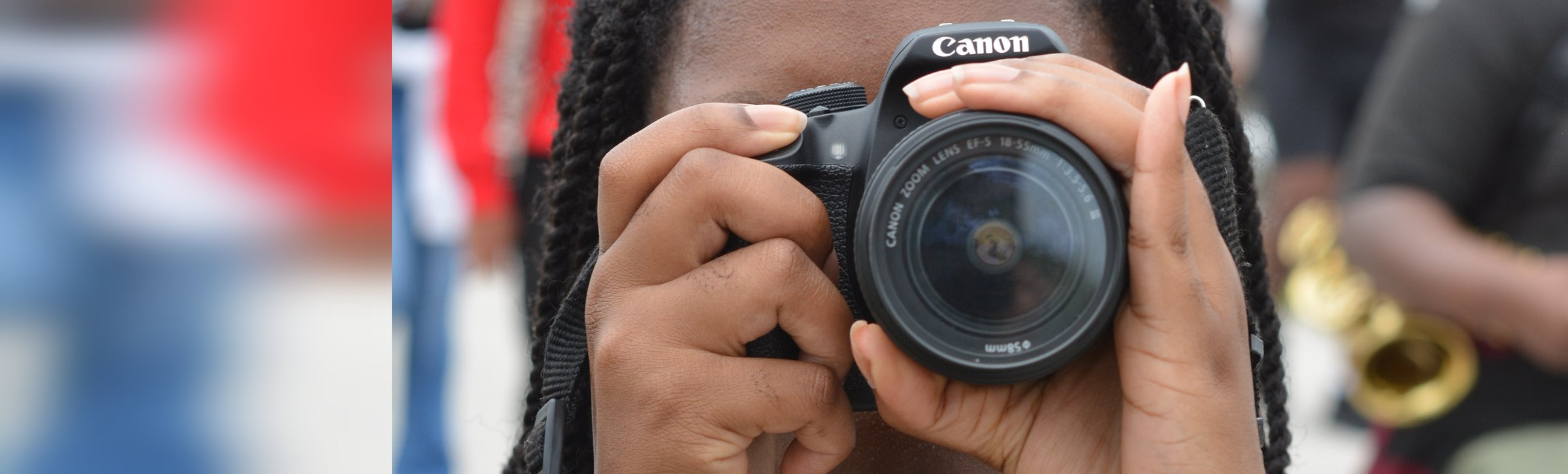 A C.R.A.F.T. student raising a Canon camera to the eye